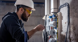 Electrician working on switchboard